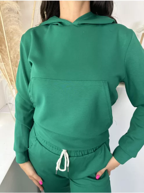Rugalmas anyagú melegítő szett. Zsebes, kapucnis, rövid derekú felsőrész, gumis, magas derekú, zsebes nadrággal. A Modell S/M méretet visel. (S/M és L/XL méretekben.)